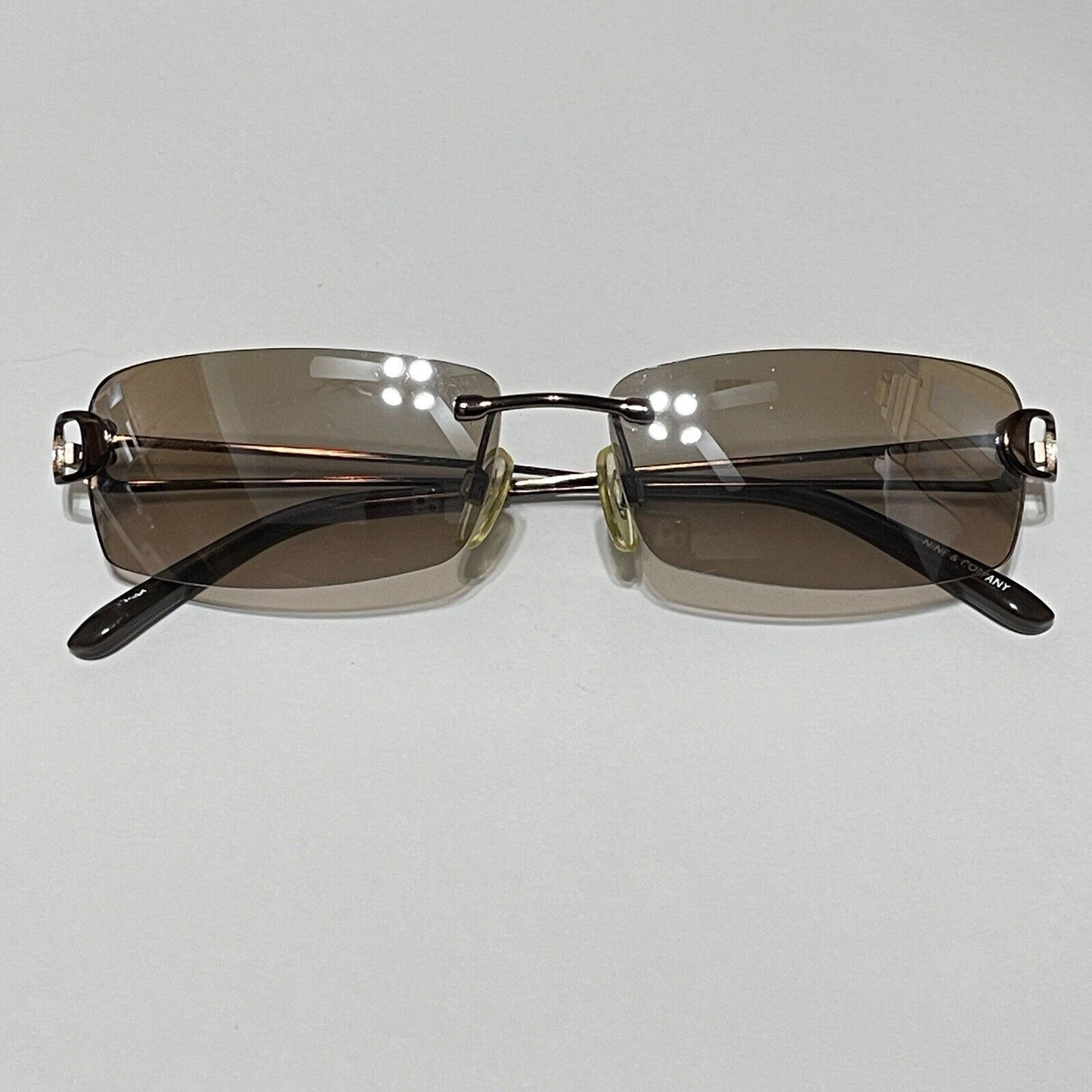 Nine & Co Rimless Sunglasses Bronze Metal Brown Lenses Rectangle